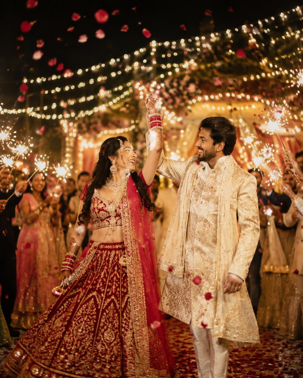 Couple dancing among sparklers and rose petals